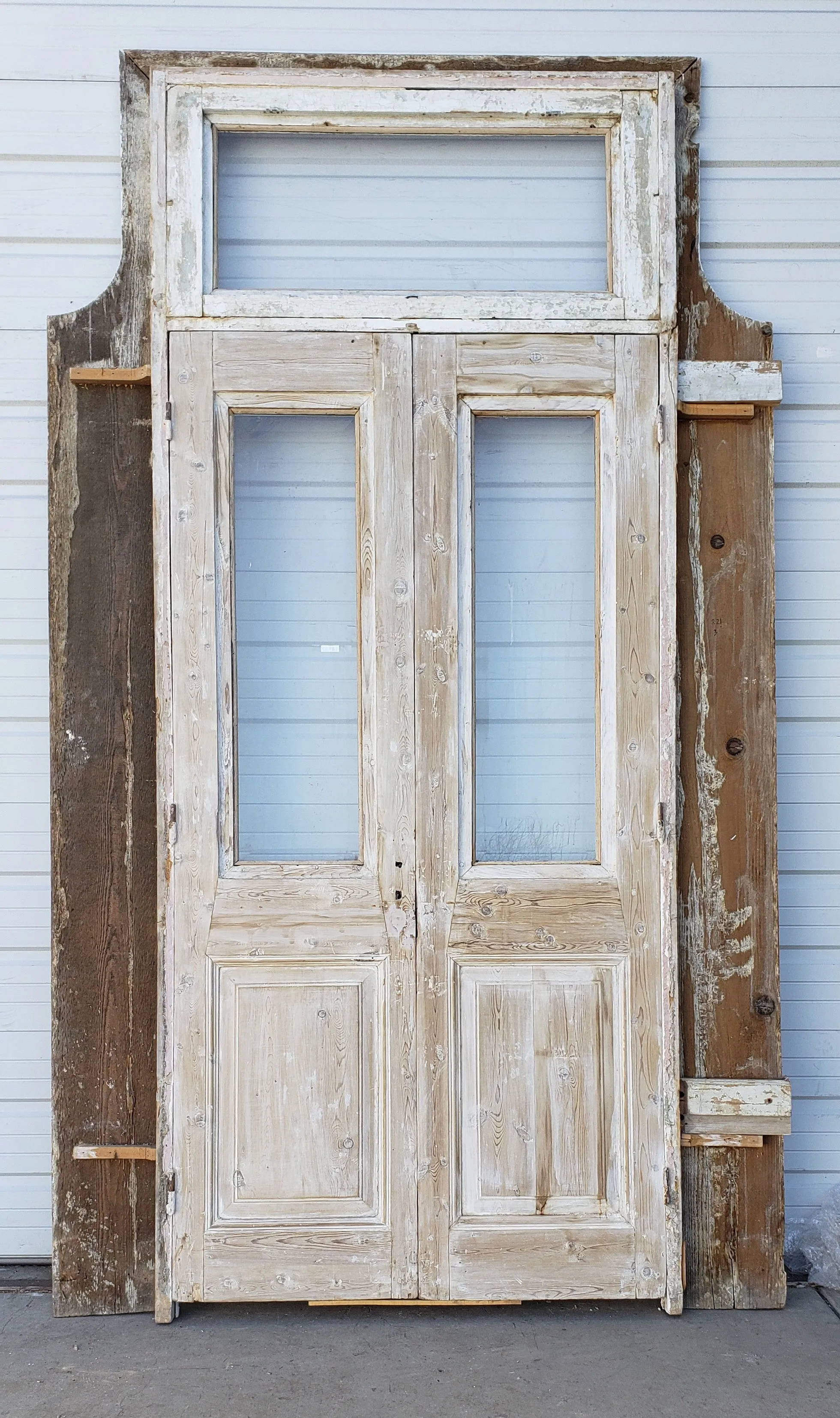 Pair of Washed Antique Wood Single Lite French Carved Doors with Transom Window