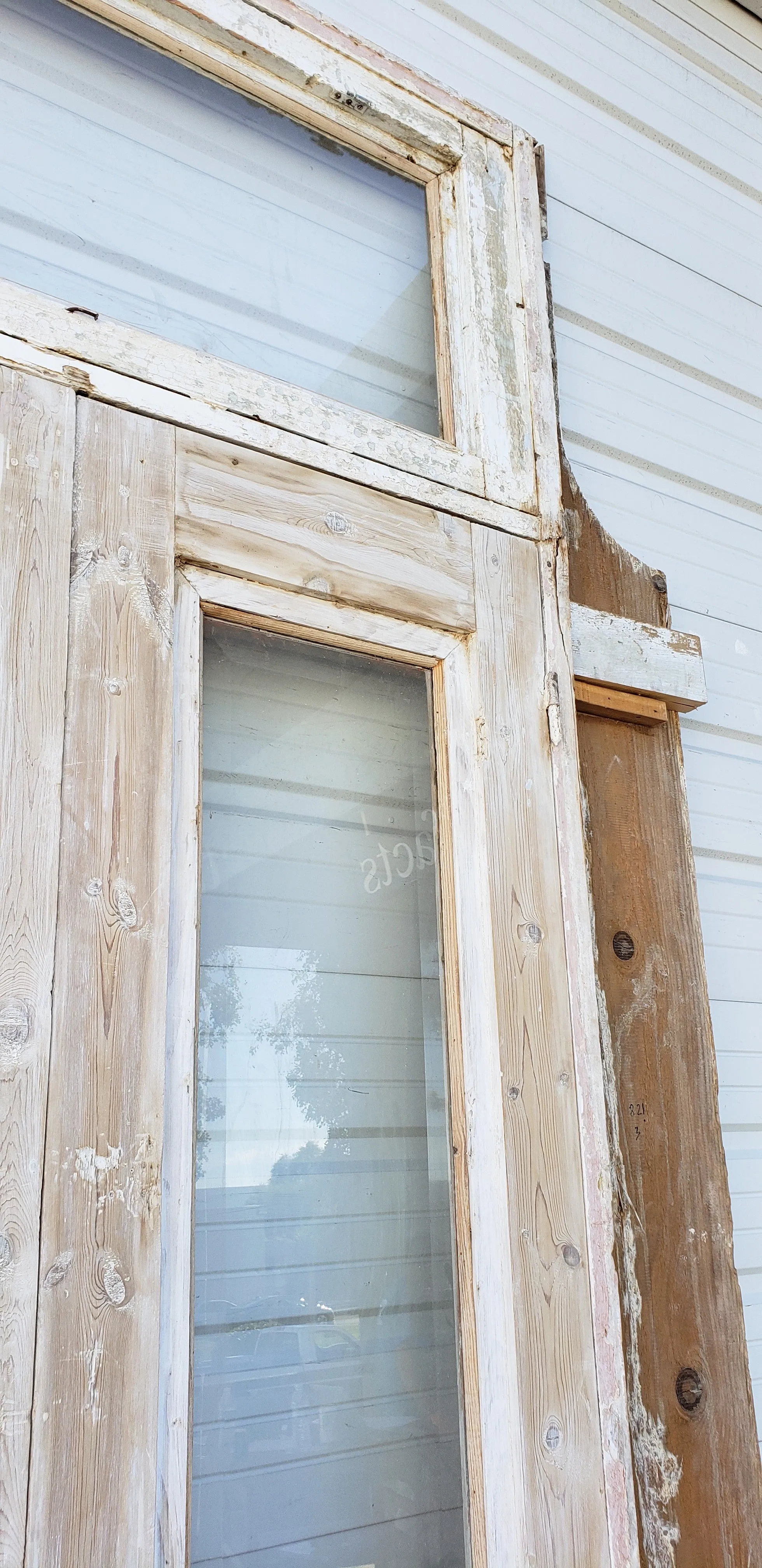 Pair of Washed Antique Wood Single Lite French Carved Doors with Transom Window