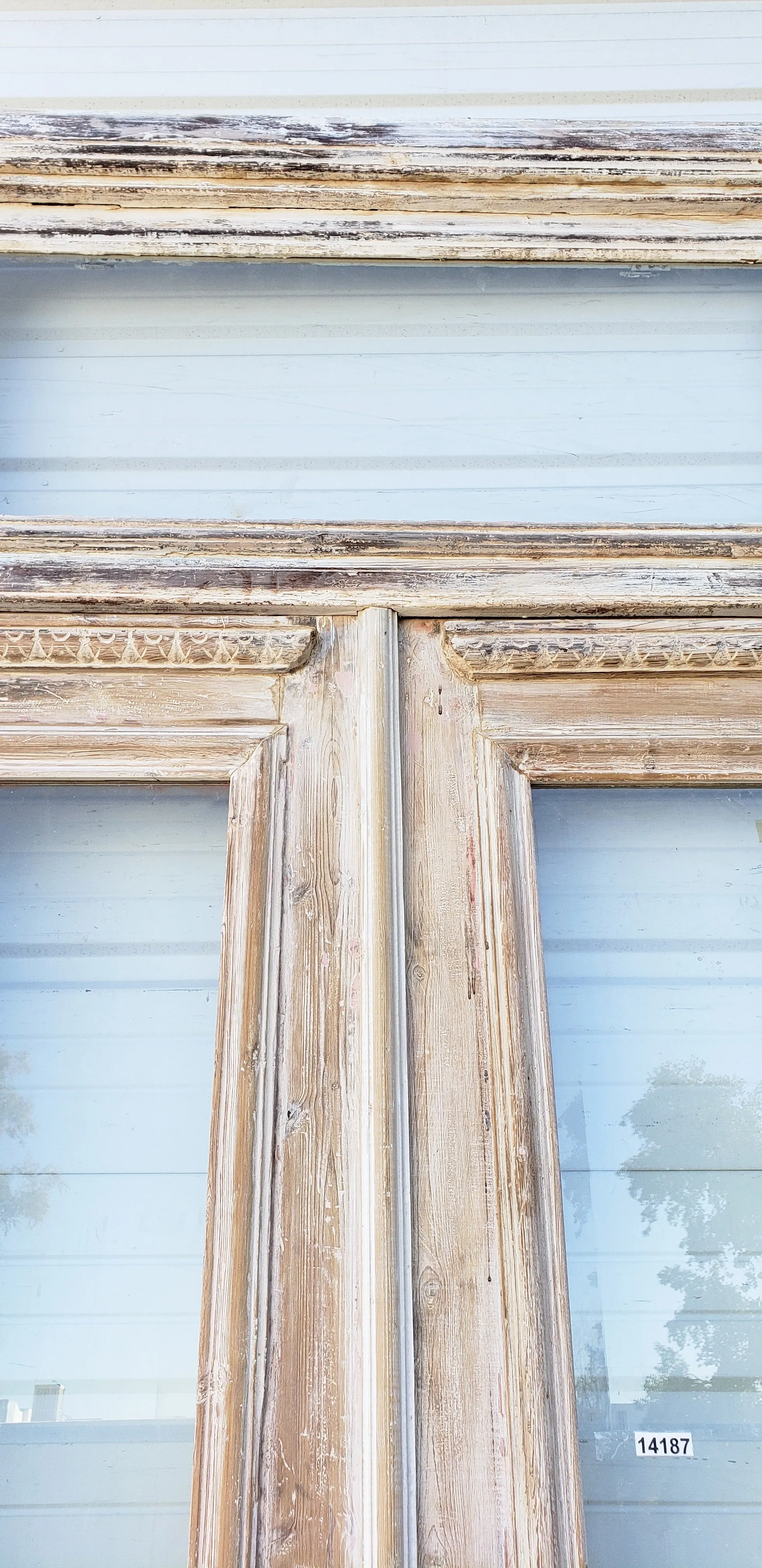 Pair of Washed Antique Wood Single Lite French Carved Doors with Transom Window